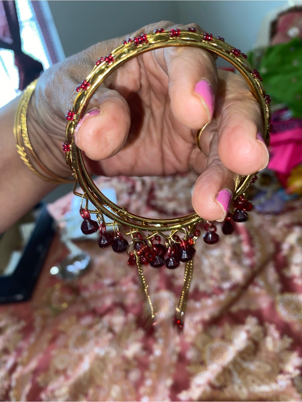 Gold Tone Bangle Bracelet with Red Bead Charms
